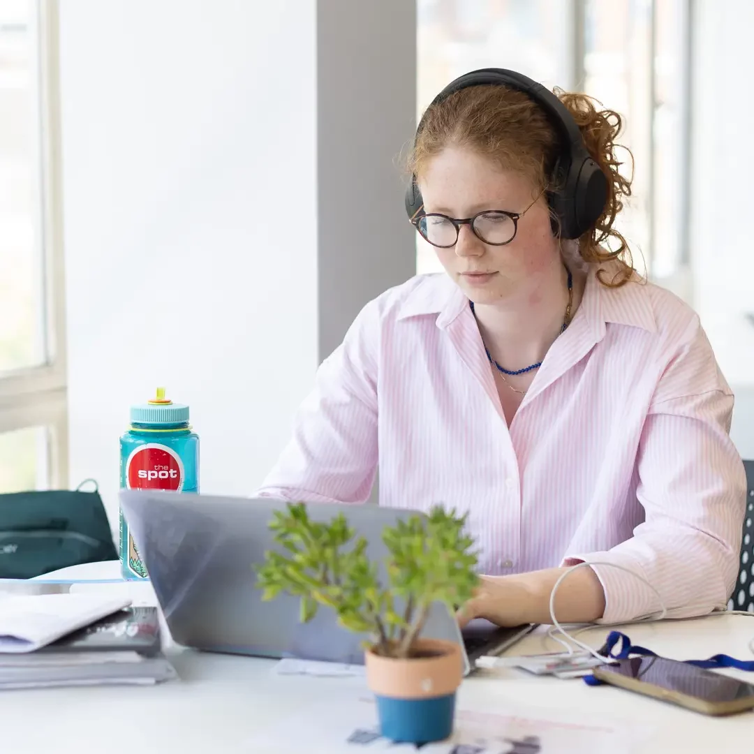 A healthcare professional or student working on her laptop